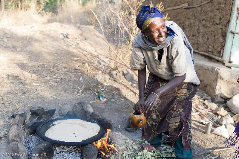 20120402_072643 Nikon D3S 2x3.jpg - We tried making this injera.   The lady is laughing at our attempt